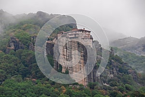 Meteora - Panoramic view on foggy day of Holy Orthodox Monastery of Rousanou (St. Barbara), Kalambaka, Meteora, Greece.