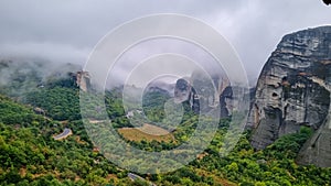 Meteora - Panoramic view on foggy day of Holy Orthodox Monastery of Rousanou St. Barbara, Kalambaka, Meteora, Greece.