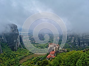 Meteora - Scenic view of  Holy Monastery of St Nicholas Anapafsas seen from forest on cloudy day, Kalambaka, Meteora