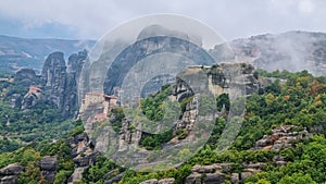 Meteora - Scenic view of  Holy Monastery of St Nicholas Anapafsas seen from forest on cloudy day, Kalambaka, Meteora