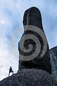 Meteora - Silhouette of woman standing next to a massive rock formation near village Kastraki, Meteora, Greece