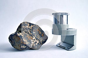 Meteorite and magnifying glass photo