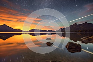 meteors streaking above a tranquil lake reflection