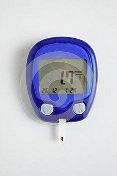 The meter is insulated on a white background. Blood sugar measurements. The concept of diabetes. Hypoglycemia