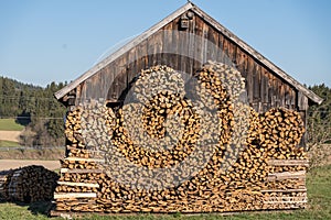 Meter wood in front of an old wooden hut - firewood