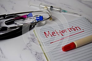 Metformin write on a book and keyword isolated on Office Desk. Healthcare/Medical Concept