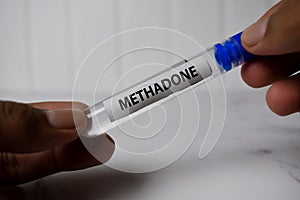 Methadone text on tube bottle. Top view isolated on office desk. Healthcare/Medical concept