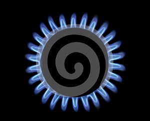 Methane gas flame of a home cooker, top view, black background