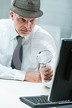 Methodical man magnifies computer, seeks details