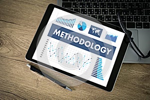 METHODOLOGY CONTEPT Business team hands at work with financial reports and a laptop