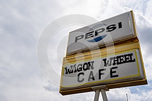 Methow, Washington - July 5, 2019: Old abandoned sign for the former Wagon Wheel Cafe and motel, closed for many years, along the