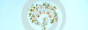 MeToo on wooden alphabet, surrounded by flowers depicting improvised women gender sign used for concept of sexual harrassment