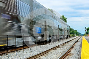 A Metra passenger commuter train blurs past