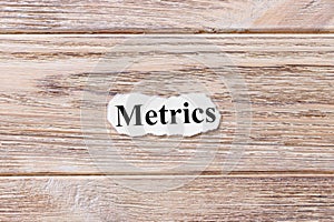 Metrics of the word on paper. concept. Words of Metrics on a wooden background