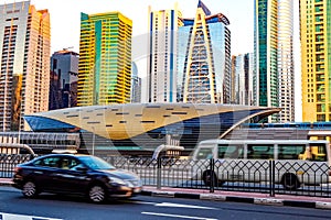 Metro railway among among glass skyscrapers in Dubai. Traffic on street in Dubai. Cityscape skyline. Urban background.