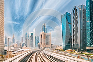 Metro road among glass skyscrapers in Dubai. Metropolitan railway among modern glass skyscrapers in Dubai. Traffic on