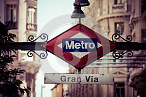 Metro Sign on blurred city, Madrid