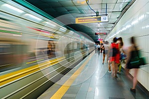 Metro station with blurred traffic and crowd, Modern subway station with people