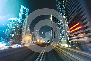 Metro track with skyline at night Dubai - UAE