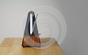 Metronome in action, closeup, and on a plain background