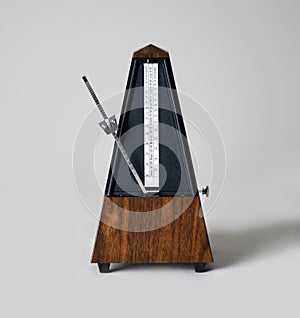 Metronome in action, closeup, and on a plain background
