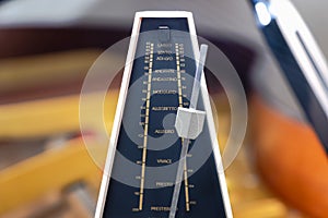 Metronome with pendulum to keep rhythm and tempo for piano, classical music, musicians photo