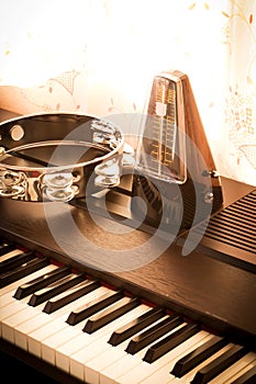 Metronome on a piano with tambourine.