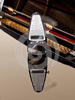 Metronome ticking and reflected on piano