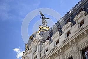 Metropolis - one of the most beautiful buildings in Madrid, Spain with dramatic blue cloudy sky on the background