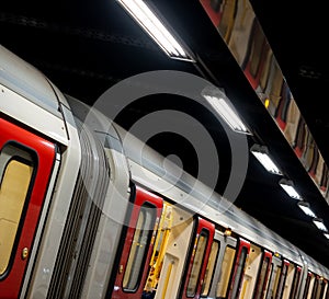 Train on the platform at Euston Square Underground Station, London UK, showing reflection of train on ceiling above.
