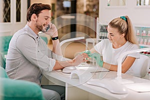 Metrosexual talking on the phone while visiting beauty salon photo