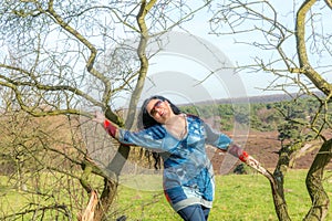 Mexican adult chubby woman posing between bare trees