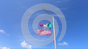 Mexican and American flags flying together