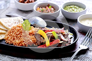Mexican beef fajitas with flour tortillas and rice