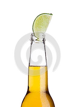 Mexican beer bottle with lime slice and frost