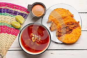 Mexican birria consomme and beef tacos on white background