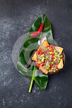 Mexican black bean soup with homemade fried tortillas totopos nachos served with guacamole