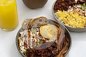 mexican breakfast, chilaquiles with egg and toasted bread, chorizo de un costado deep dish photo