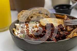 mexican breakfast, chilaquiles with egg and toasted bread, chorizo de un costado deep dish photo