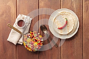 Mexican breakfast food. Huevos rancheros, baked eggs, shot from the top with pico de gallo salad