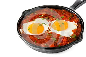 Mexican breakfast: Huevos rancheros in iron frying pan isolated