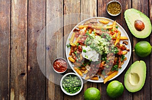 Mexican carne asada fries on wooden table top photo