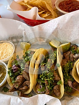 Mexican carne asada street tacos with chips and salsa. photo