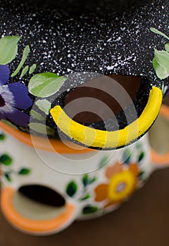 Mexican ceramic pot, multiple holes, grey and white backgrounds