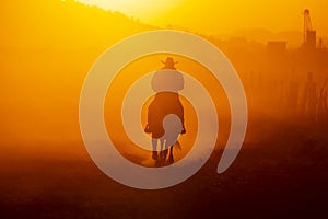 A Mexican Charro Cowboy Rounds Up A Herd of Horses Running Through The Field On A Mexican Ranch At Sunrise