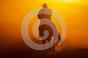 A Mexican Charro Cowboy Rounds Up A Herd of Horses Running Through The Field On A Mexican Ranch At Sunrise