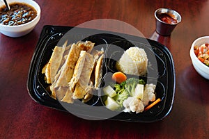 Mexican chicken fajitas with rice and broccolies accompanied with salsas and french fries