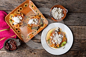 Mexican chicken tinga toasts with chipotle pepper and fresh cheese also called tostadas photo