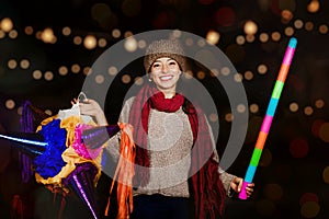 Mexican Christmas, Latin Girl Holding a colorful PiÃ±ata and celebrating a traditional Posada in Mexico City