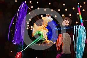 Mexican Christmas, Latin Girl Holding a colorful PiÃ±ata and celebrating a traditional Posada in Mexico City